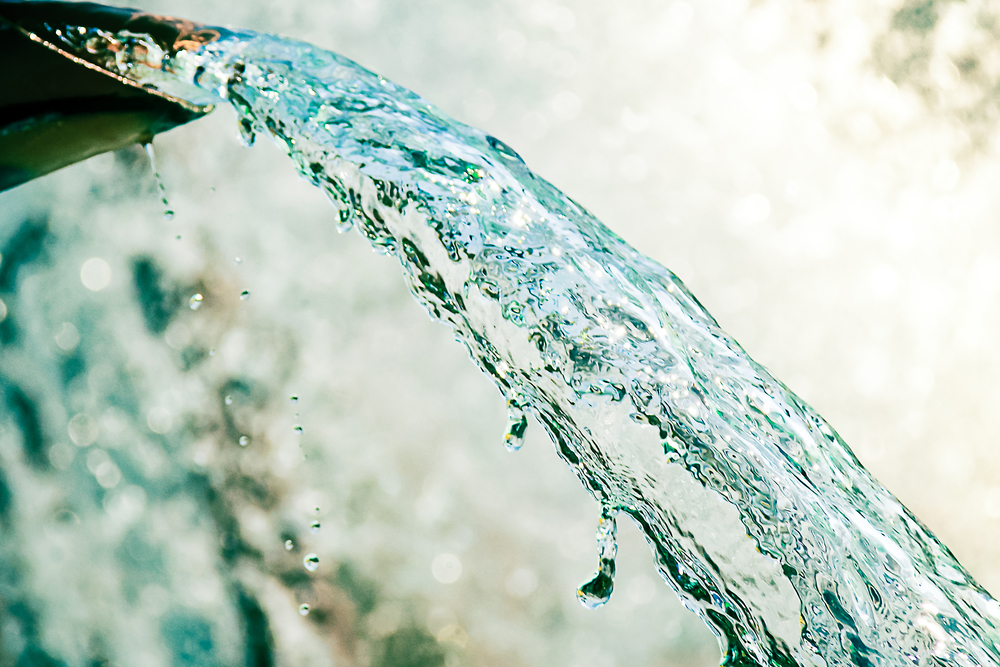 closeup of water pouring out of pipe