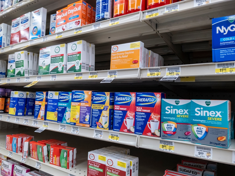 view of pharmacy shelves with assorted cold medicine on them
