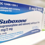 boxes of suboxone 8mg and 2mg sublingual film on pharmacist shelf