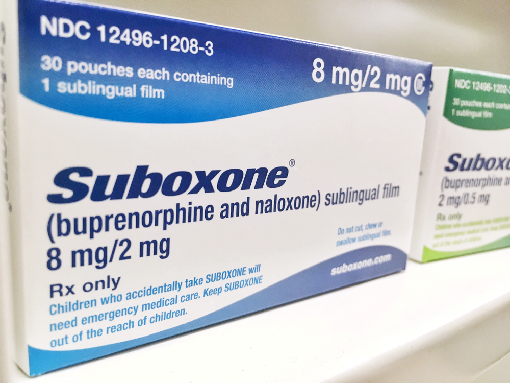 boxes of suboxone 8mg and 2mg sublingual film on pharmacist shelf