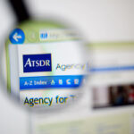 Photo of the Agency for Toxic Substances and Disease Registry (ATSDR) homepage on a monitor screen through a magnifying glass.