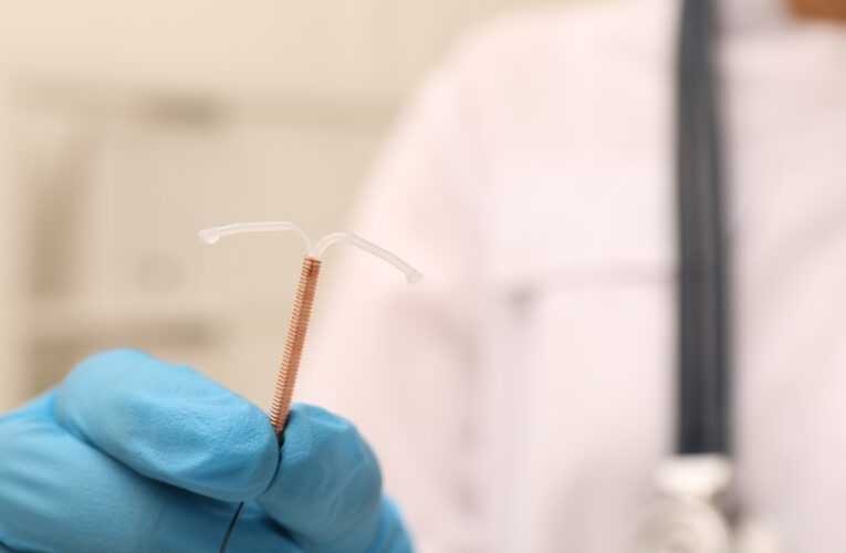 doctor holding a paragard copper wound IUD with a blurred background