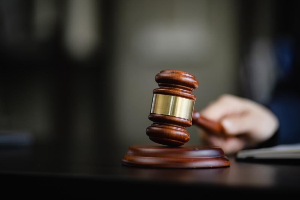 selective focus closeup of a wooden gavel held by a judge after verdict