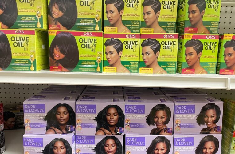 Boxes of at-home permanent hair relaxer kits on display on a store shelf