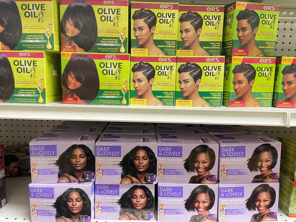 Boxes of at-home permanent hair relaxer kits on display on a store shelf