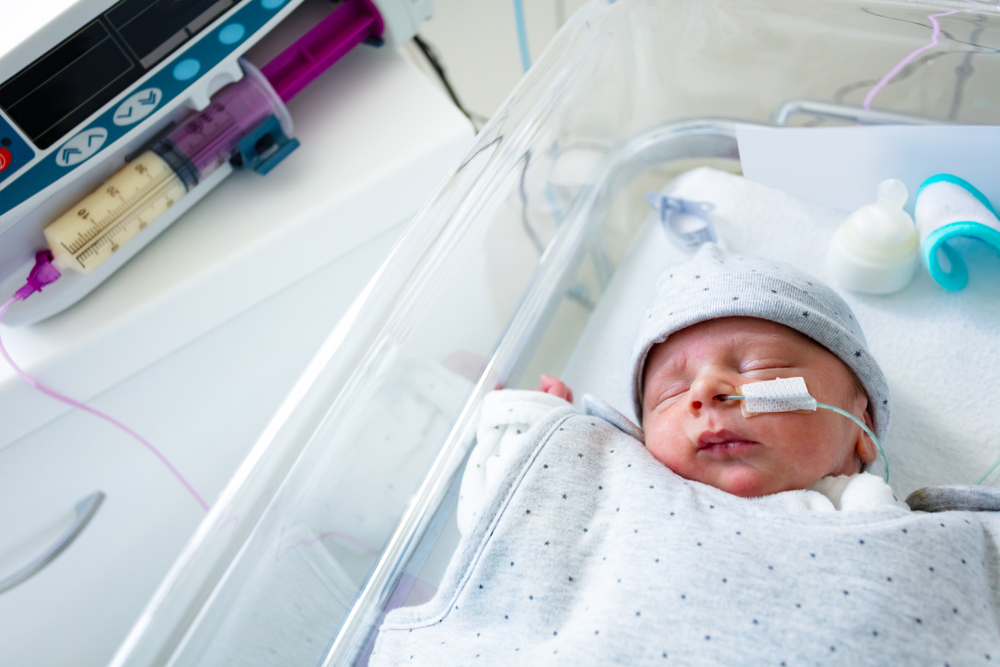 premature baby being fed formula through a tube in the hospital