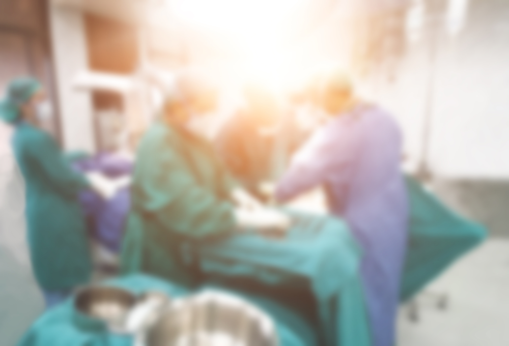 Abstract blur background of medical team is performing baby cesarean section in operating room at hospital.